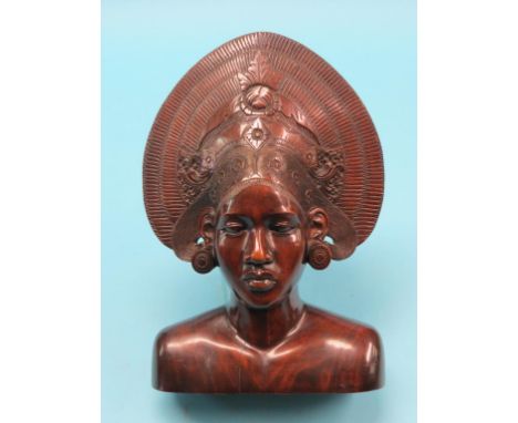 An eastern carved hardwood portrait bust, perhaps Sri Lankan, youth with elaborate head-dress, 15in.