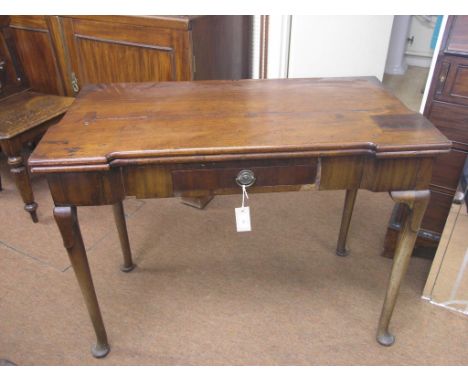 A George II mahogany card table, rectangular top enclosing square counter-wells and baize lining, single, oak-lined frieze dr