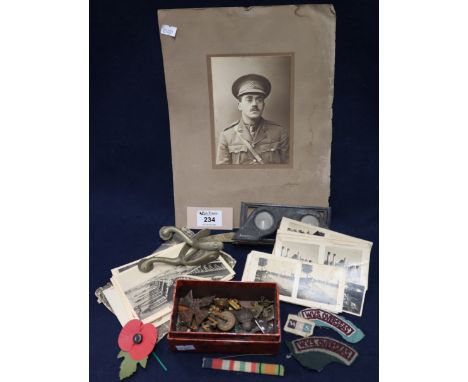 Box of military insignia and badges, various, pair of military nickel spurs, a photographic portrait of a First World War arm