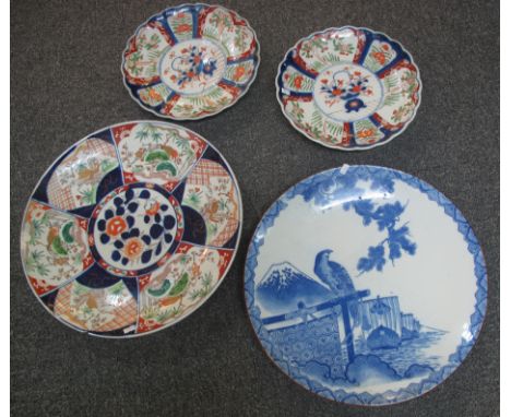 Large Japanese Imari porcelain charger and another larger Japanese porcelain charger in blue and white with bird of prey amon