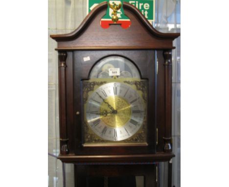 Reproduction mahogany cased longcase clock having moon face with Roman numerals and silver chapter ring, pendulum and two wei