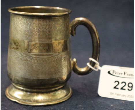 Small engine turned, baluster shaped, silver christening mug engraved with the name 'John'.  (B.P. 24% incl. VAT)