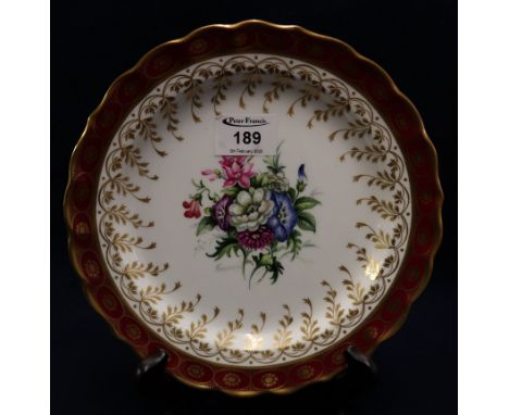 Royal Worcester bone china cabinet plate, hand painted and gilded with a central flower spray. Signed Freeman. Printed marks 