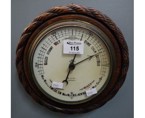 Oak rope twist moulded aneroid barometer. (B.P. 24% incl. VAT)