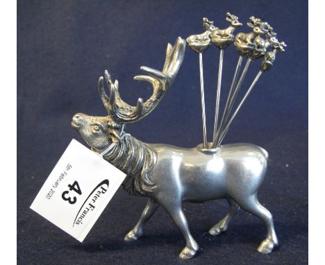 Vintage cocktail stick holder in the form of a striding stag, together with a set of six cocktail sticks with stag terminals.