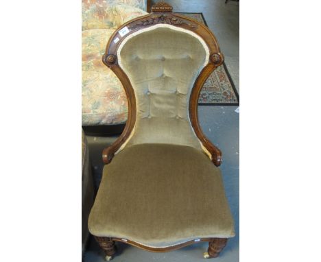 Victorian walnut button back showframe nursing or bedroom chair on turned supports and ceramic casters.(B.P. 24% incl. VAT)