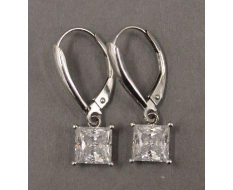 A pair of 14 K white gold earrings. Each 6 mm wide.
