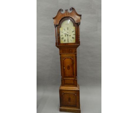 An early 19th century oak and mahogany eight-day longcase clock. 210 cm high.