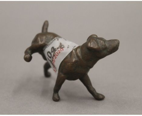 A bronze model of a dog cocking his leg. 6.5 cm long.