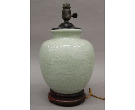 A Chinese celadon pottery lamp. 37 cm high.