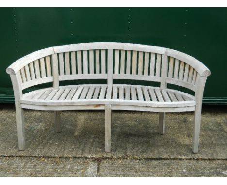 A curved wooden garden bench