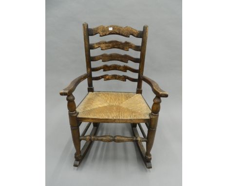 An oak ladder back rocking chair