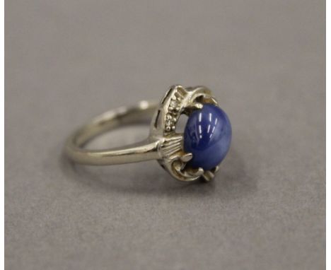 A 14 K white gold and star sapphire ring. Ring Size N.