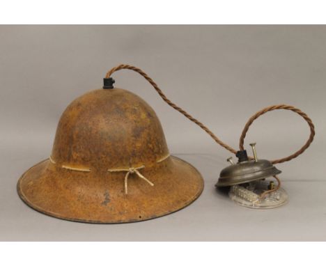 A Belgian military helmet, converted to a hanging lamp. 29 cm wide. 