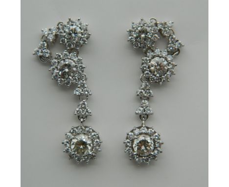 A pair of 18 K white gold diamond drop earrings, the drops each set with a 0.5 carat diamond. Each 3.5 cm high.