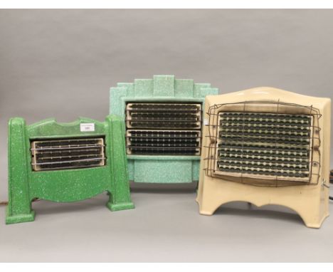 Three vintage enamel decorated heaters and a modern fan. The largest 38 cm high.
