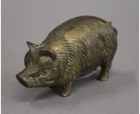 A brass model of a pig. 9 cm long.