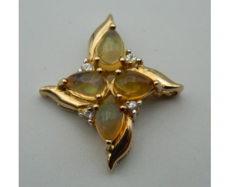 A 9 ct gold diamond and opal pendant. 2.5 cm wide. 2.8 grammes total weight