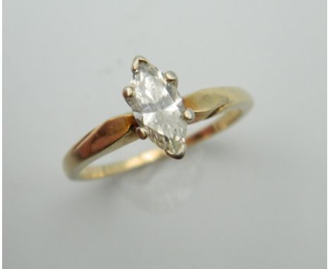 A 14 K gold marquise cut diamond solitaire ring. Ring Size M. 