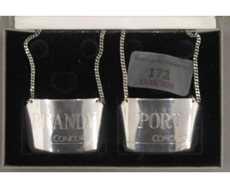 A boxed pair of Concorde silver decanter labels