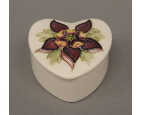A Moorcroft heart shaped trinket pot and a boxed Wedgwood trinket pot. The former 3.5 cm high.