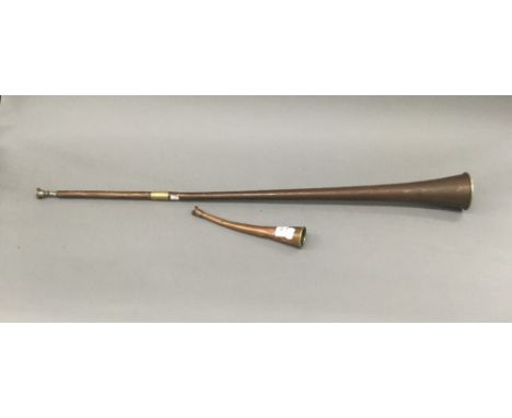 An antique copper and brass coach horn with 19th century mouthpiece, together with a vintage hunting horn. The former 92 cm l