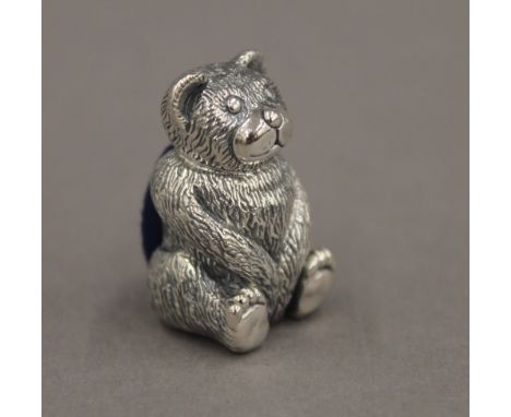 A silver pin cushion formed as a teddy bear