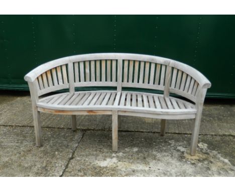 A curved wooden garden bench