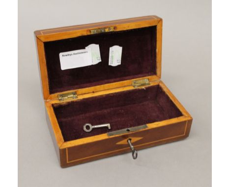 An Edwardian mahogany inlaid trinket box. 15 cm wide.
