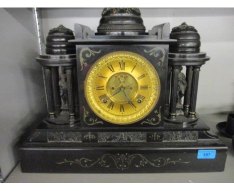 A Victorian black marble cased clock of architectural form flanked by a pair of figures 