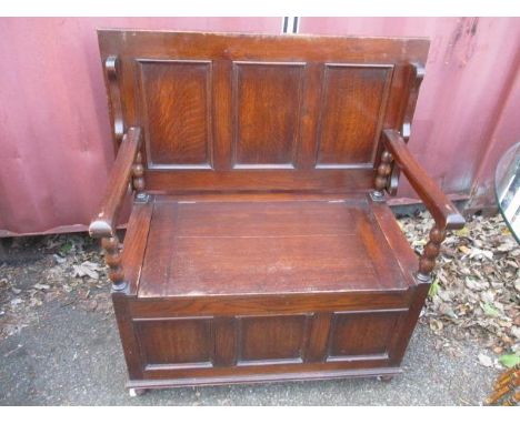 An early 20th century oak panelled monks bench, 37" h x 35 1/2"w 
