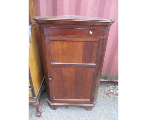 A George III tri-panelled oak corner cupboard on bracket feet 44 1/4"h x 28"w 