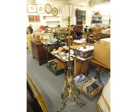 A Victorian adjustable converted oil lamp with a wrought iron base and lamp shade 