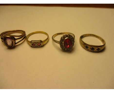 A silver and blue stone ring, a 9ct gold and silver ruby ring and two others 