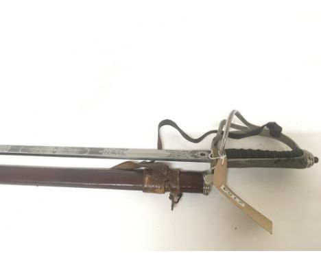 A British officers George V Royal Artillery sword with a Mortuary type hilt wired grip. Engraved blade leather scabbard blade