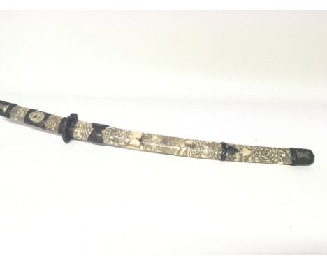 A Japanese late 19th century katana sword with quality carved bone segment grip and conforming scabbard with ornate bronzed m