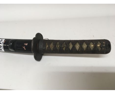 A Japanese late 19th or early 20th century katana sword with a bound shagreen grip and lacquered scabbard length 64cm