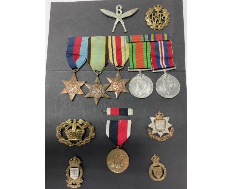 A collection of WW2 medals and badges including a Japanese Army of occupation medal.