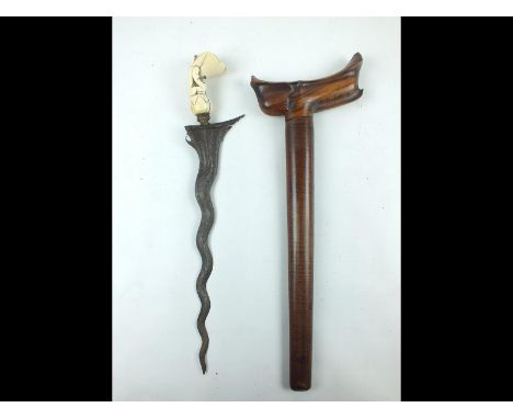 A 19th Century ivory hilted Kris, 32.5cm wavy watered steel blade, characteristic carved ivory hilt, contained in its wooden 