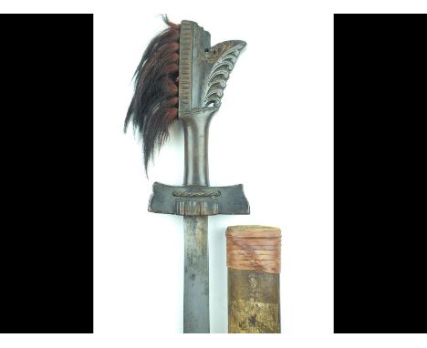 A Kampilan Moro or Dyak sword, 30.5inch blade with recurving spur to the tip, characteristic carved wooden hilt with dyed hai