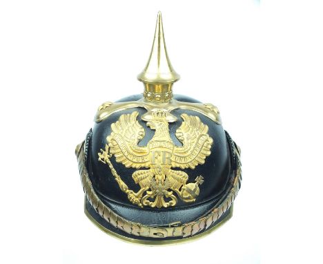 A Prussian Paymaster Officer's Pickelhaube, the black leather skull with square cut peak and gilt brass fittings including sp