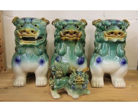 Four Chinese ceramic lion dog figures.