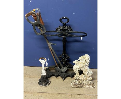 A Victorian/cast iron "style" hall stick stand, 73cmH, with  two old shooting sticks,  and a pair of door stops 