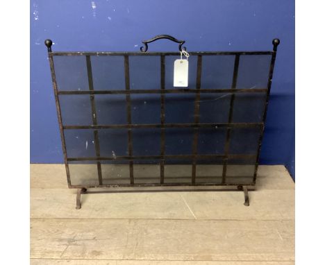 A black metal fire screen, with square lattice pattern, 86cmH x 102cmW 