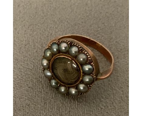 A C19th 9ct gold mourning ring, central quartz panel with a surround of split pearls, 3.8g 