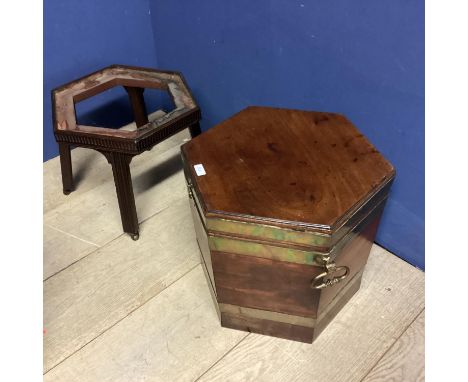 A mahogany and brass bound hexagonal wine cellerette ring carrying handles, on fitted stand with 4 raised legs to casters, 73