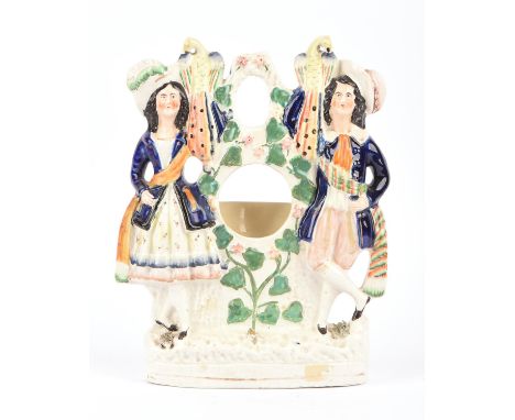 Sir Roger Moore: mid to late 19th century Staffordshire spill vase - fashioned in the style of a lady and gentleman in hats a