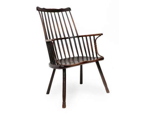 An Early 19th Century Ash Comb-Back Spindle Armchair, with double spindle back support above curved armrests, the moulded sea