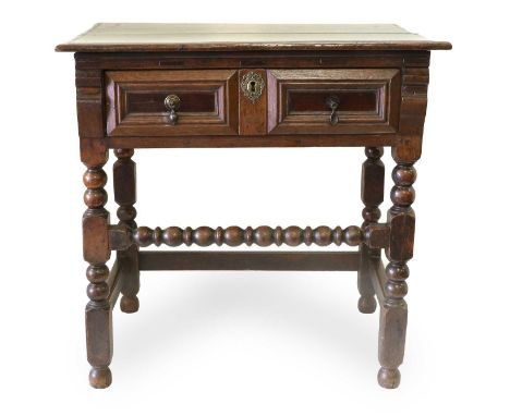 An Oak Side Table, circa 1700, the moulded top above a two-as-one frieze drawer between scrolled brackets, on bobbin-turned a