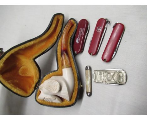 C20th cased Meerschaum pipe carved with a gundog, simulated amber mouthpiece, three Victorinox "Swiss Army" knives and mid C2